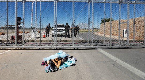 Shoes and toys are left at the gate in protest by a bipartisan delegation of mayors from across the country at a detention facility where children of migrants are being held, at the port of entry in Tornillo, Texas.