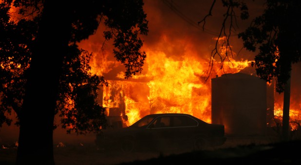A structure burns out of control in the River Fire (Mendocino Complex) in Lakeport, California.