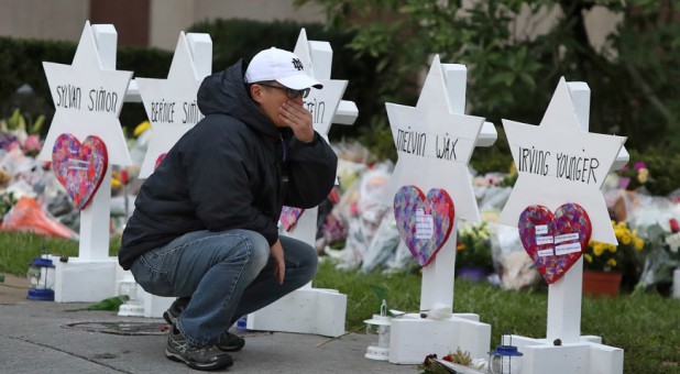 A man reacts at a makeshift memorial outside the Tree of Life synagogue following Saturday's shooting at the synagogue in Pittsburgh.