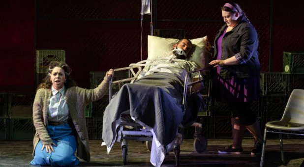 With Daddy (Timothy J. Bruno) dying, his wife Nelda (Eliza Bonet), left, and estranged daughter Kayla (Alexandria Shiner) have different feelings toward him in AOI’s “Taking Up Serpents” production by Washington National Opera at the Kennedy Center.