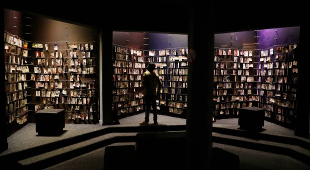 A visitor looks at an exhibition displaying pictures of the Rwandan Genocide victims donated by survivors at the Genocide Memorial in Gisozi in Kigali, Rwanda.