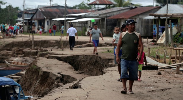 Residents walk in an area affected by a quake in Puerto Santa Gema, on the outskirts of Yurimaguas, in the Amazon region, Peru.