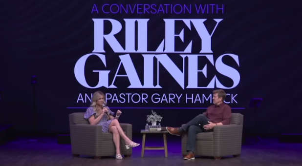 Riley Gaines talks with Pastor Gary Hamrick.