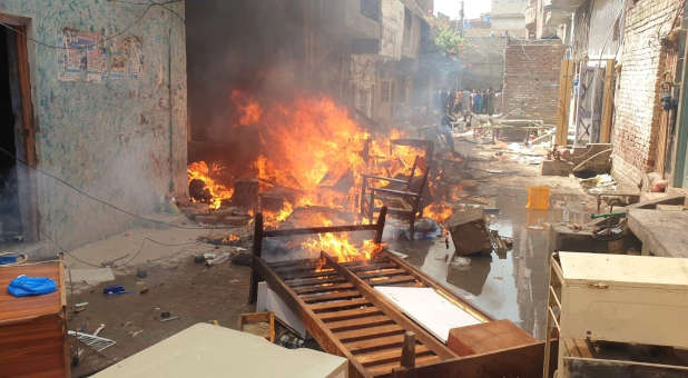 Furniture burning in an alleyway.