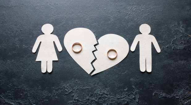 Cut outs of a man and woman's marriage ending.