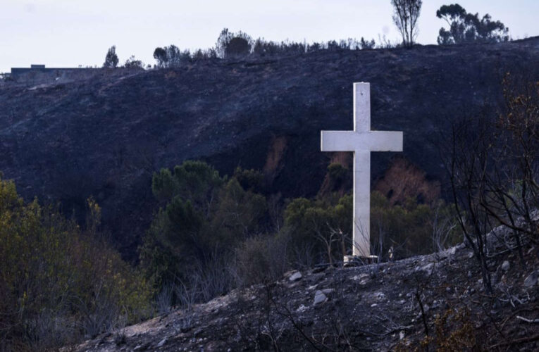 Faithful ‘Teary-Eyed’ by Wooden Cross Still Standing After Wildfire