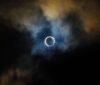 solar eclipse amid clouds